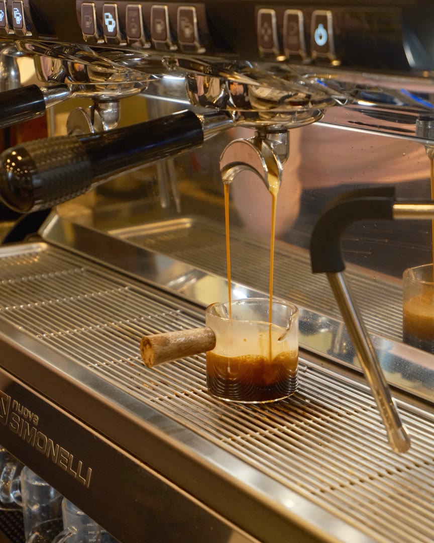 A double shot of espresso pouring from the machine at The Snug Mug