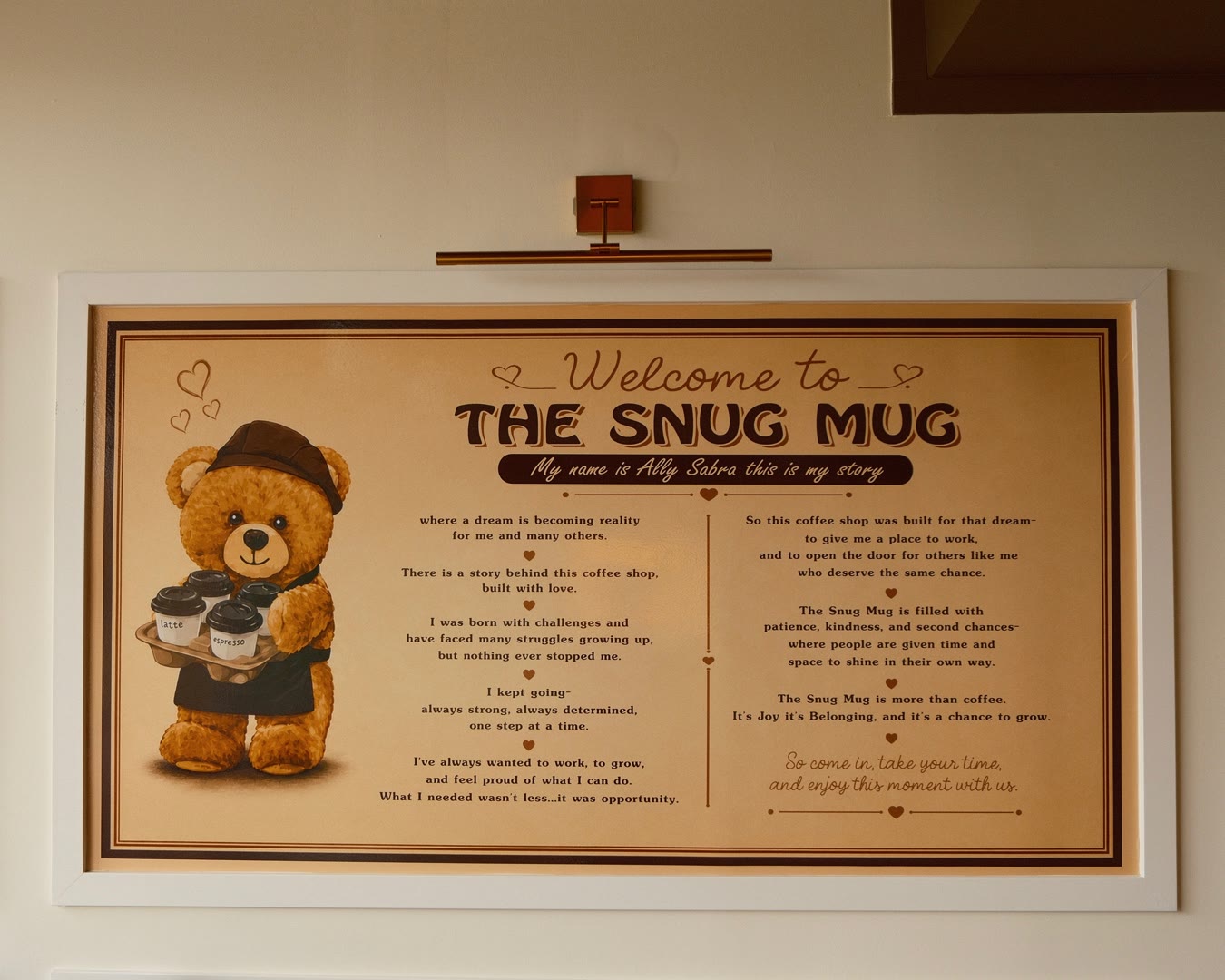 Ally's story board, framed and lit on the wall inside The Snug Mug